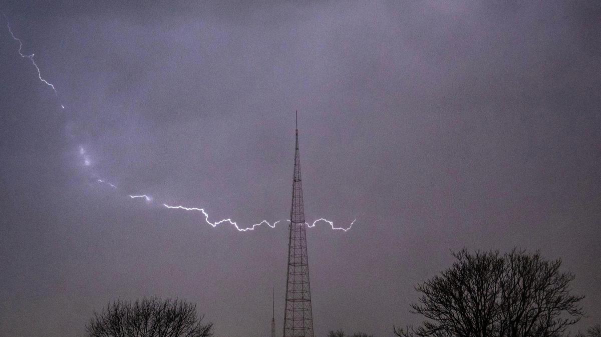 A bolt of lighting arcs across the sky over mid-town Kansas City on Wednesday, March 13, 2024, in Kansas City.