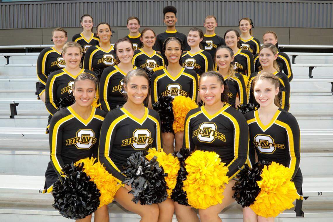 A Black Ottawa University cheerleader, Talynn Jefferson, in the center, says she was kicked off the team after being verbally attacked by a coach who said her braids were too long.