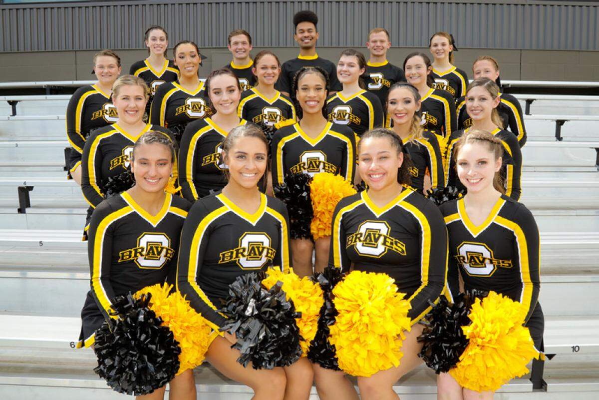 A Black Ottawa University cheerleader, Talyn Jefferson, in the center, says she was kicked off the team after being verbally attacked by a coach who said her braids were too long.