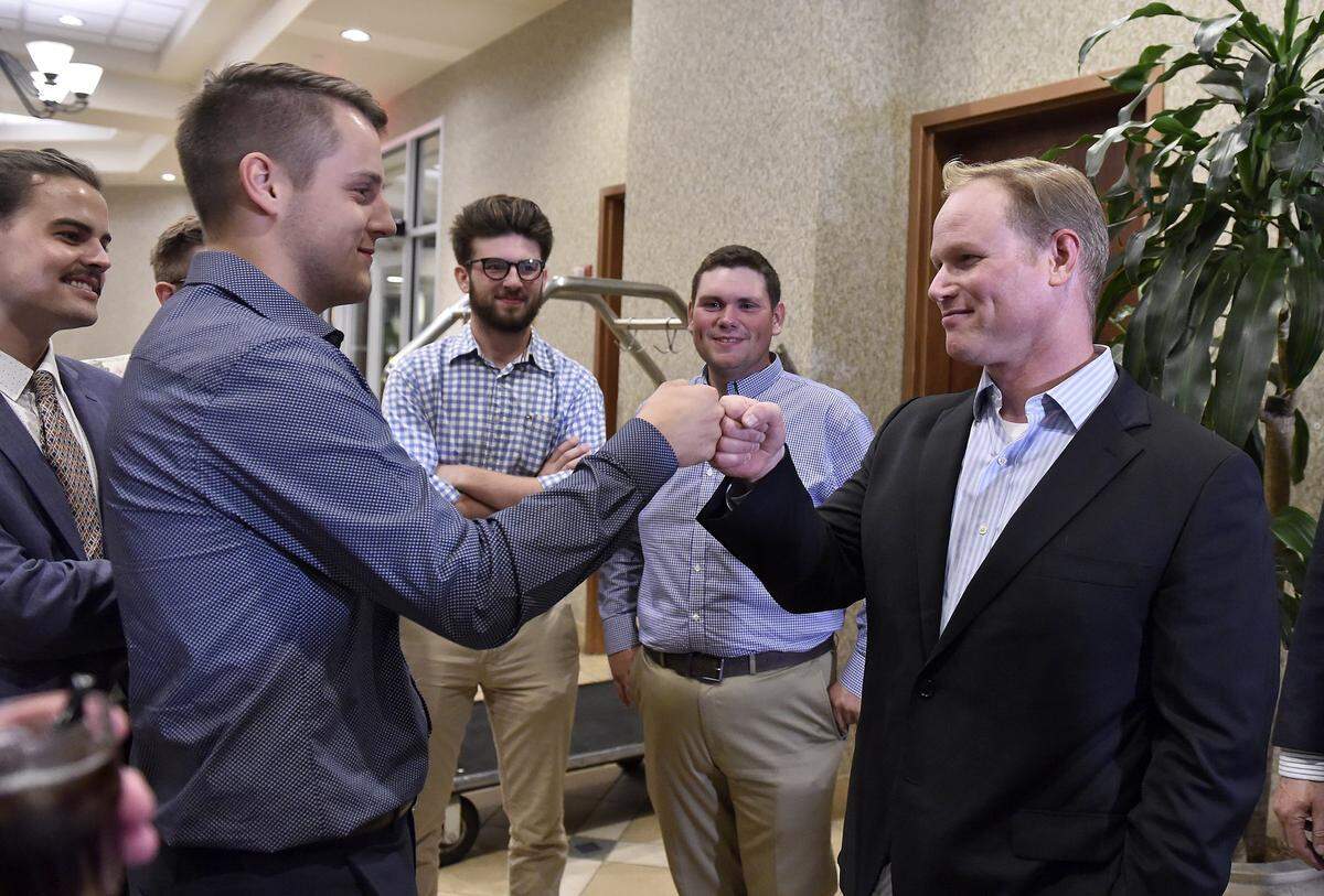 Steve Watkins (right), U.S. combat veteran, engineer, and Republican candidate for Kansas’ 2nd Congressional District celebrates his primary win with a fist bump with campaign staffer Isaac Leverenz at his watch party at the Capitol Plaza Hotel in Topeka Tuesday, Aug. 6.