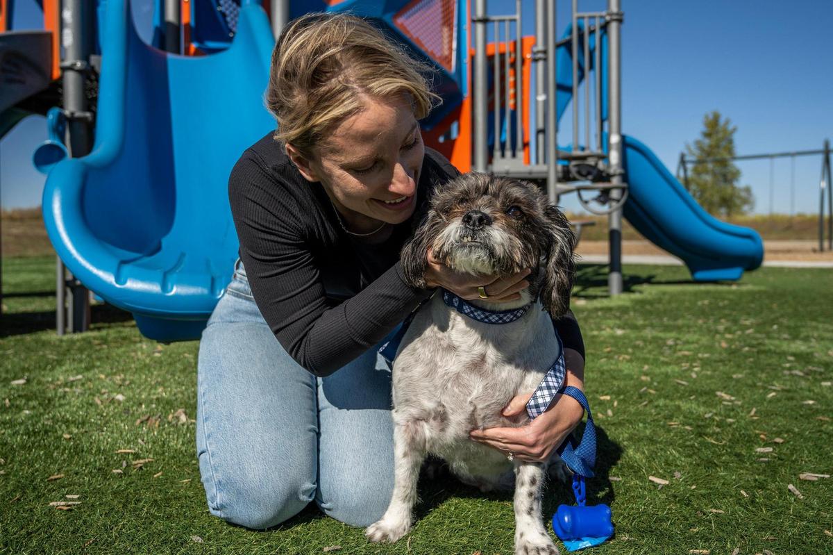 Sammy DeBauche holds her dog Murphy for a portrait at Anne Garney Park on Thursday, Oct. 17, 2024, in Kansas City.