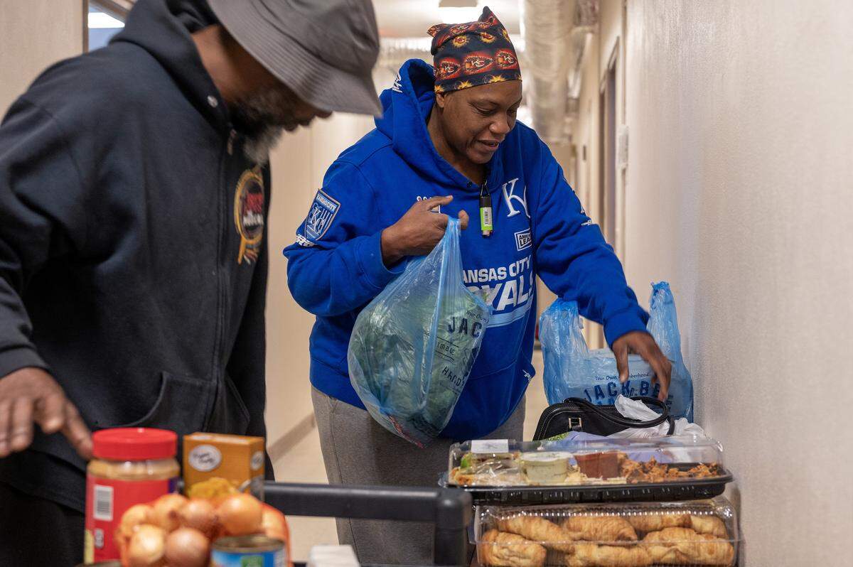 Cynthia Ransburg, a client of the Redemptorist Center, bags food at the center on Monday, Nov. 3, 2025, in Kansas City. Food pantries across the region are struggling to meet demand as many families face reduced or frozen SNAP benefits.