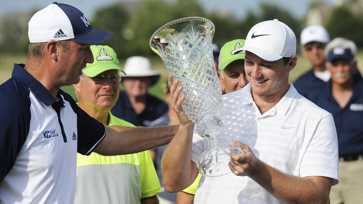 Sepp Straka, an Austrian-born graduate from the University of Georgia who now lives in Athens, Ga., is handed the KC Golf Classic trophy by tournament director Drew Van Meetren following the end of the event. Straka defeated competitor Kyle Jones by one stroke, with a total of 262, to win the Classic.