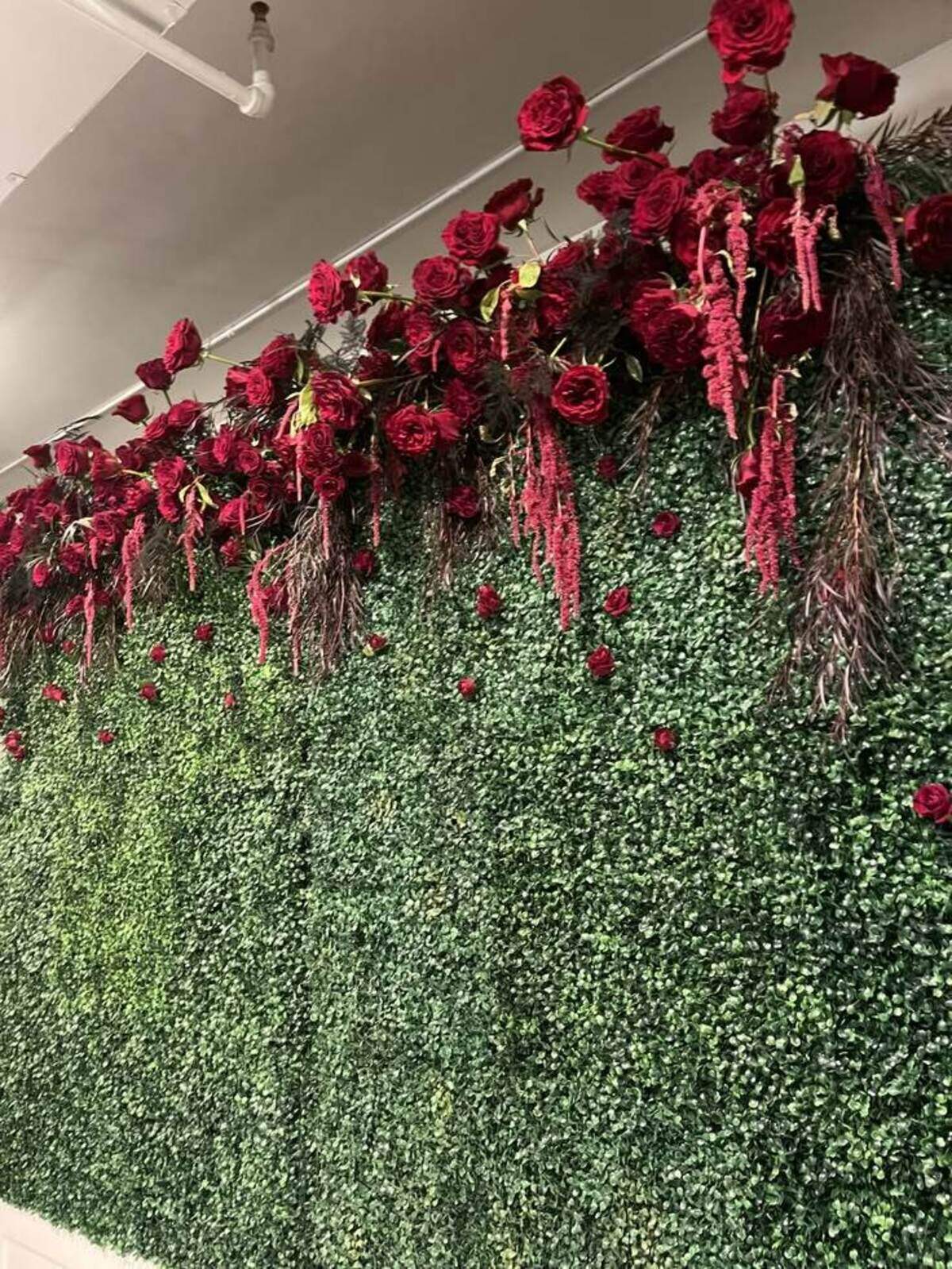 Draping, dramatic amaranthus is a popular wedding floral trend for 2026.