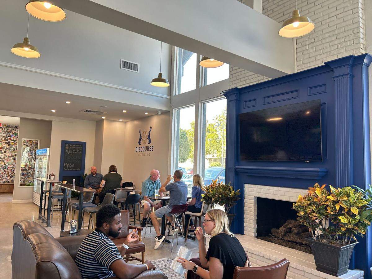 Customers can sip beer and cozy up by a fireplace inside Discourse Brewing.