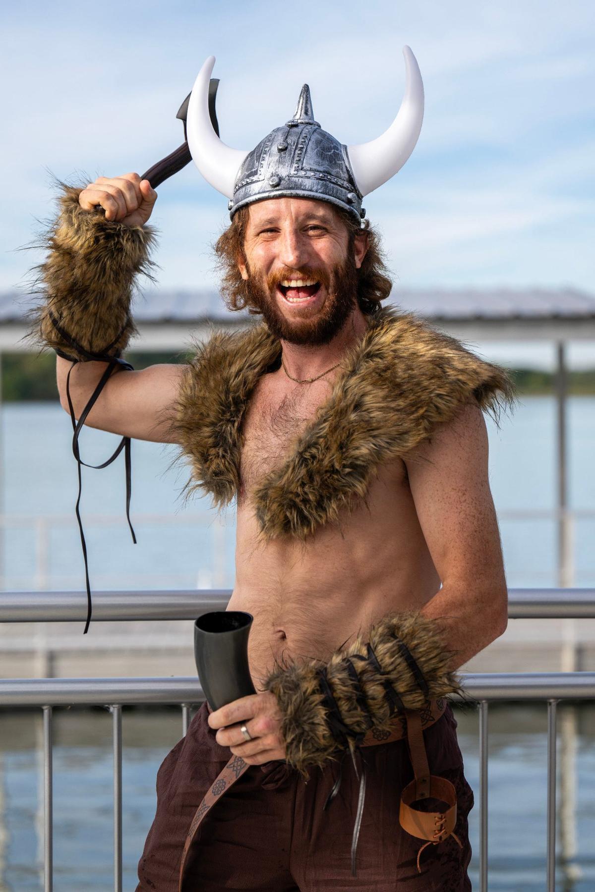 Crew member Jobi Buehler from Dragon Deez Nutz, wearing Viking attire, poses for a photo after a race during the KC Dragon Boat Festival on Saturday, Sept. 28, 2024, at Shawnee Mission Park.
