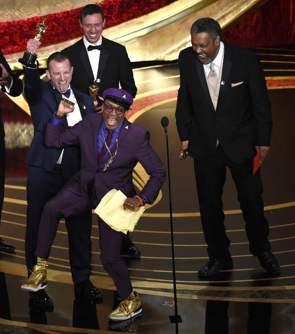Director Spike Lee, wearing purple to honor Prince, celebrated his best adapted screenplay Oscar for “BlacKkKlansman” in 2019 along with his co-writers (from left), Charlie Wachtel, David Rabinowitz and KU film professor Kevin Willmott.