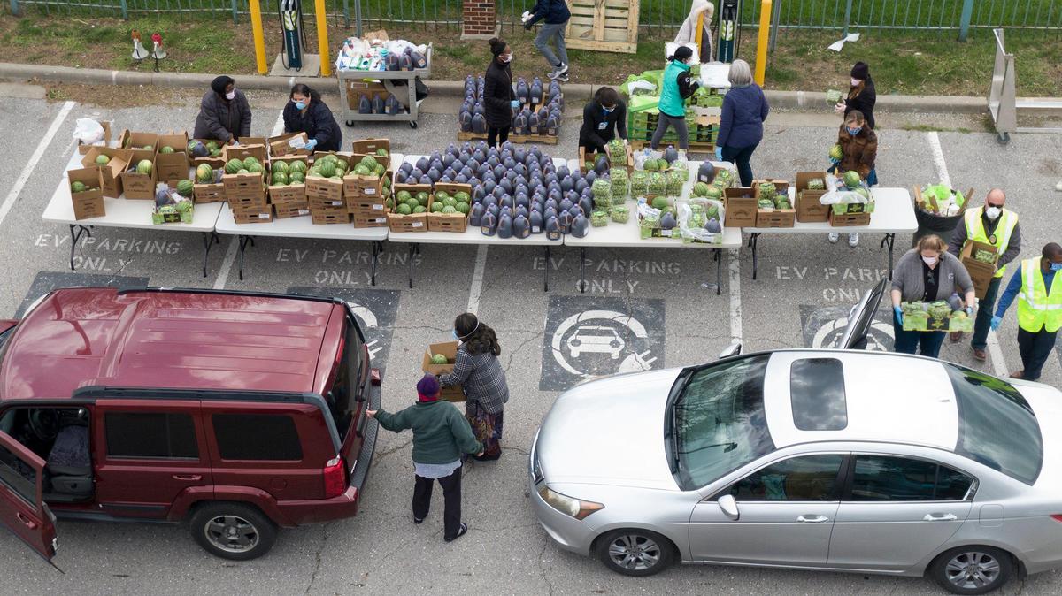 During a pop-up market, employees at the Kansas City Health Department distributed more than 4,000 pounds of fresh food on Tuesday, April 14, 2020, to people who came through the drive-thru and walk-up market in their parking lot.