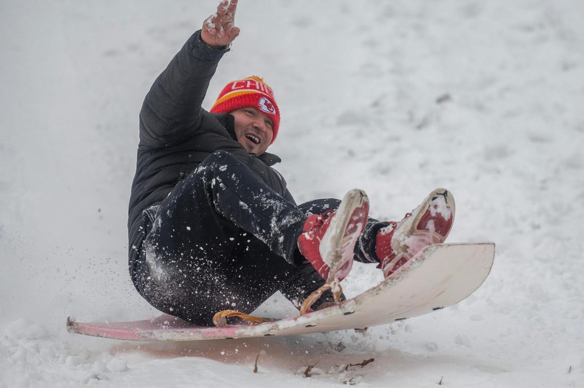 Abraham Tellez sleds down a hill at Hyde Park in Kansas City on Tuesday, Jan. 9, 2024.