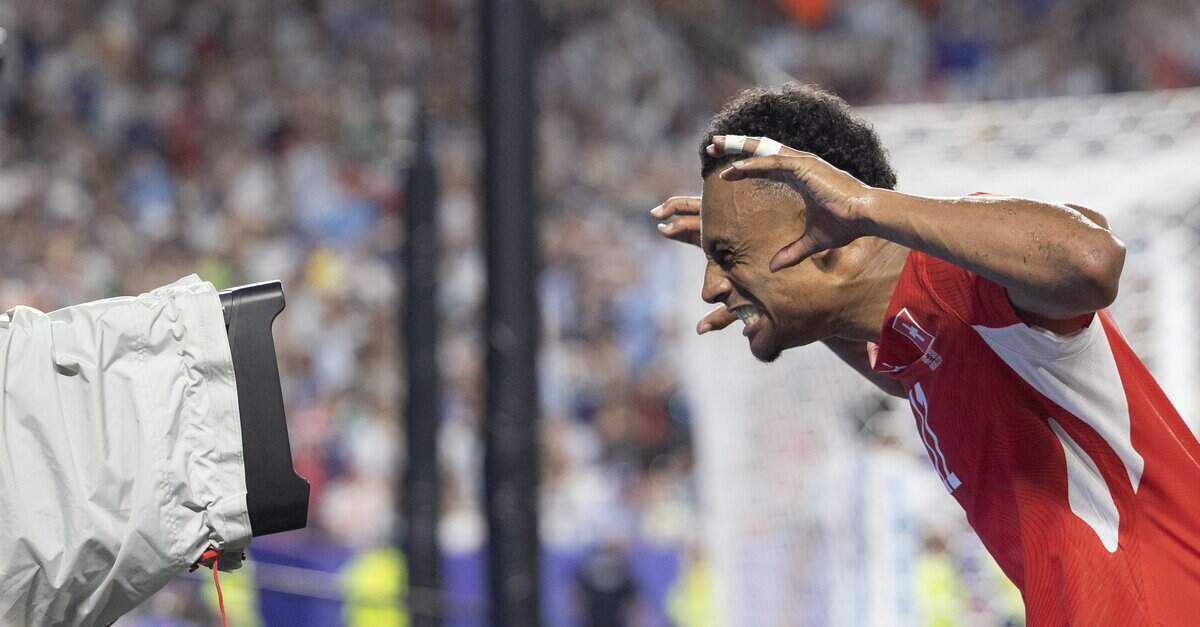 Switzerland forward Dan Ndoye (11) celebrates by mugging into a television camera after scoring a goal against Argentina during the FIFA World Cup quarterfinal match at Kansas City (Arrowhead) Stadium in Kansas City on Saturday, July 11, 2026.