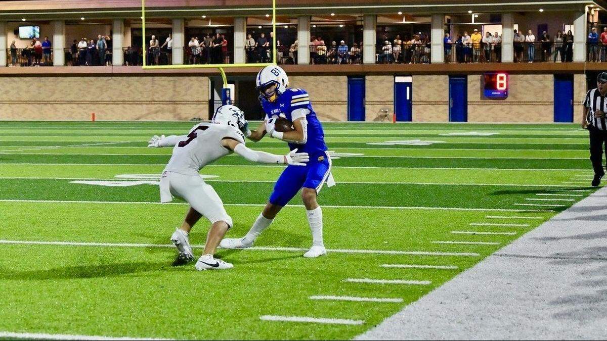 St. Pius X High School junior wide receiver Tommy Hutsler avoiding a defender.