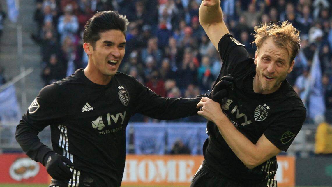 Seth Sinovic, right, celebrates with Felipe Gutierrez after Daniel Salloi gave Sporting Kansas City a 2-0 lead in the 19th minute Sunday at Children’s Mercy Park. Gutierrez assisted on both first-half goals and Salloi scored the final one in SKC’s 4-2 victory over Real Salt Lake..