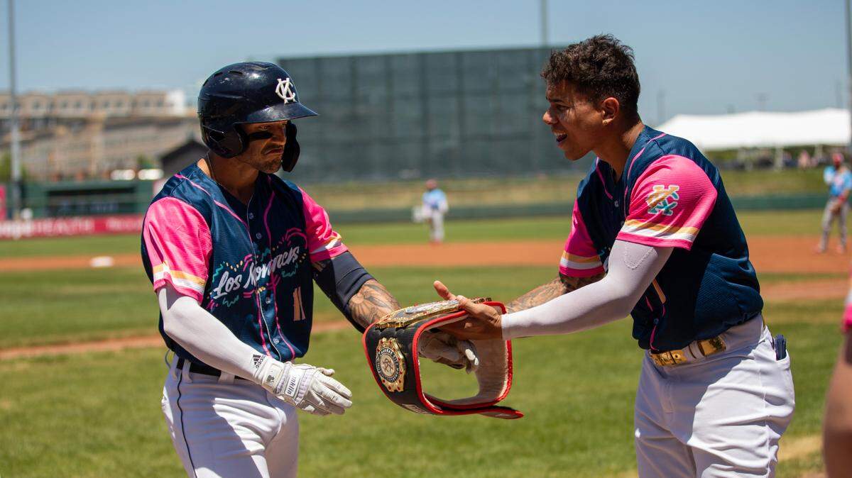 Kansas City Monarchs outfielder Dylan Rosa receives the team’s home run belt from first baseman Jan Hernandez after Rosa’s home run against the Chicago Dogs on Sunday, June 25, 2023 at Legends Field.