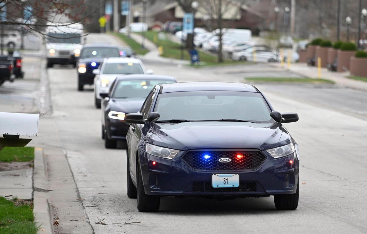 Kansas City police vehicles escort Lisa Sidenstick home after she was released Wednesday from North Kansas City Hospital. Members of the force supported Sidenstick by donating sick time, groceries, and attending a fundraiser organized by community members.