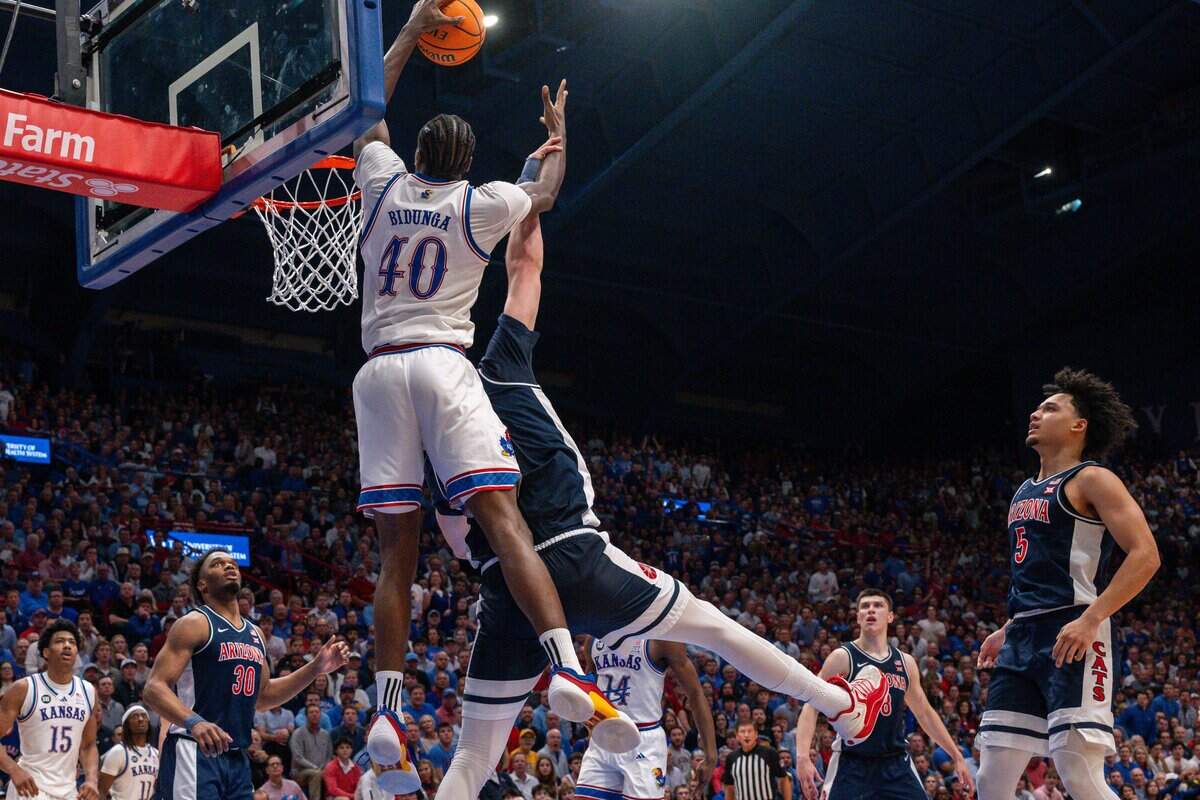 Kansas Jayhawks forward Flory Bidunga (40) dunks the ball on Arizona Wildcats center Motiejus Krivas (13) in the second half on Monday, February 9, 2026, at Allen Fieldhouse.
