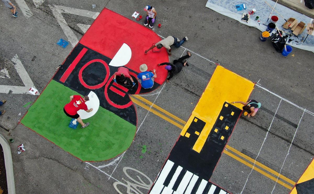 Volunteers paint the Black Lives Matter mural at the 18th and Vine Jazz District Saturday, Sept. 5, 2020. It is one of six being painted around Kansas City.