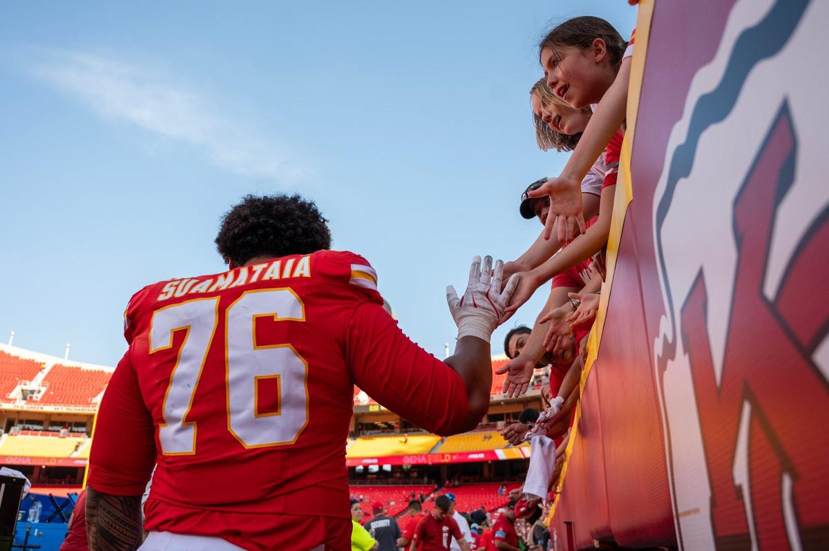 Kansas City Chiefs OT Kingsley Suamataia (76) high-fives young fans at the end of the game after the Chiefs’ 24-23 loss to the Detroit Lions on Aug. 17, 2024, at GEHA Field at Arrowhead Stadium.