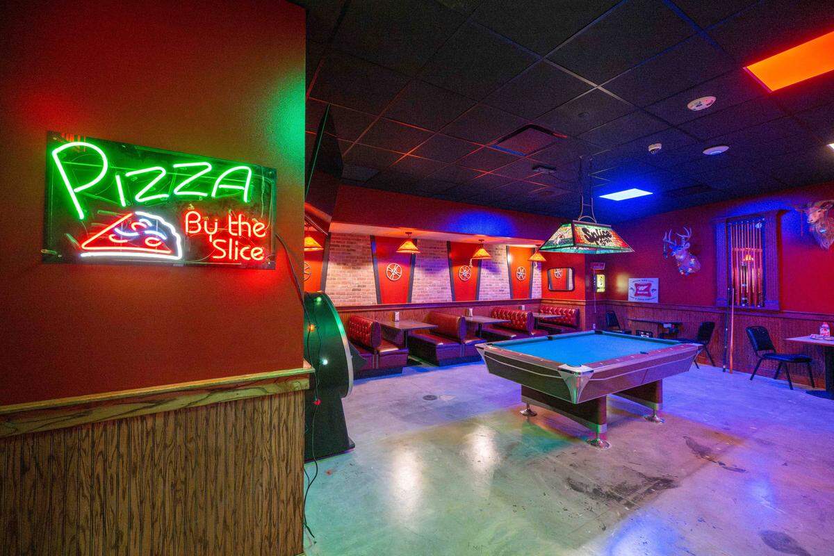 A pizza restaurant with a style right out of the 80s, inside Atlas 9, on Wednesday, Sep. 3, 2025, in Kansas City, Kansas. Designed by Kansas City-based industrial design company, Dimensional Innovations, Atlas 9 is a narrative-driven immersive art experience featuring interactive games, videos, and AI-powered experiences.