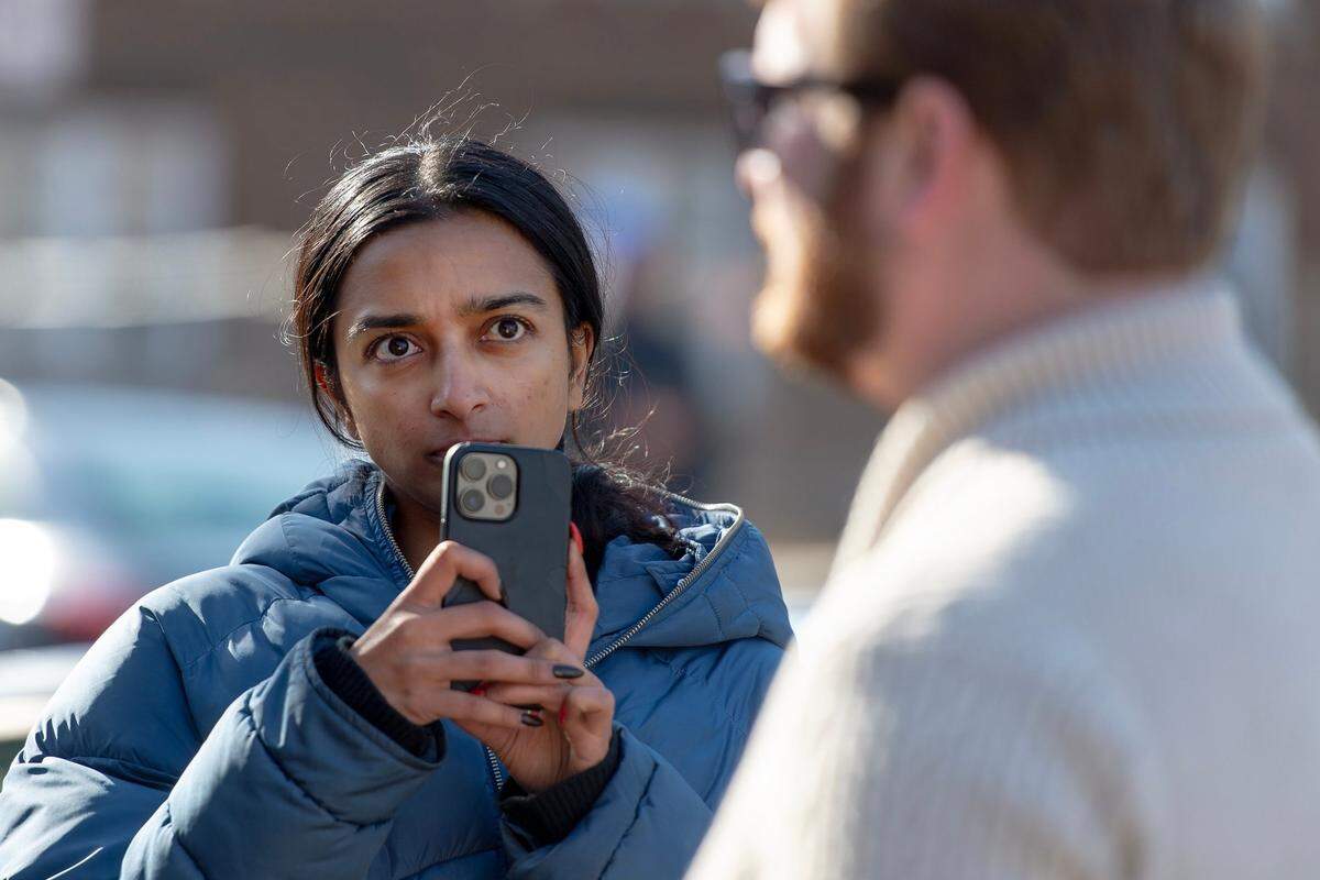 Tara Raghuveer, director of KC Tenants, records comments made by Mike Hardin, a public relations consultant for FTW Investments, outside of a northeast apartment complex on Jan. 23, 2023, in Kansas City.