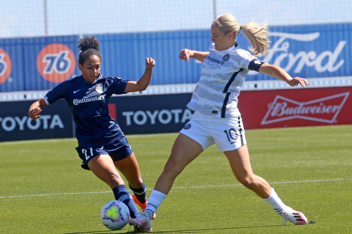 North Carolina Courage defender Addisyn Merrick (27) battles for the ball with Portland Thorns FC midfielder Lindsey Horan (10) during the first half of an NWSL Challenge Cup soccer match at Zions Bank Stadium Saturday, June 27, 2020, in Herriman, Utah. (AP Photo/Rick Bowmer)