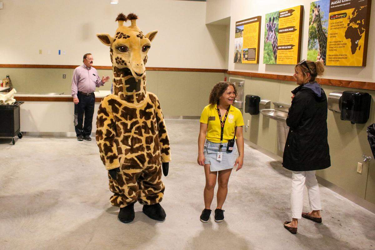 The Kansas City Zoo and Aquarium opened its new Giraffe Crossing exhibit Friday. A giraffe mascot is seen at the ribbon cutting ceremony.