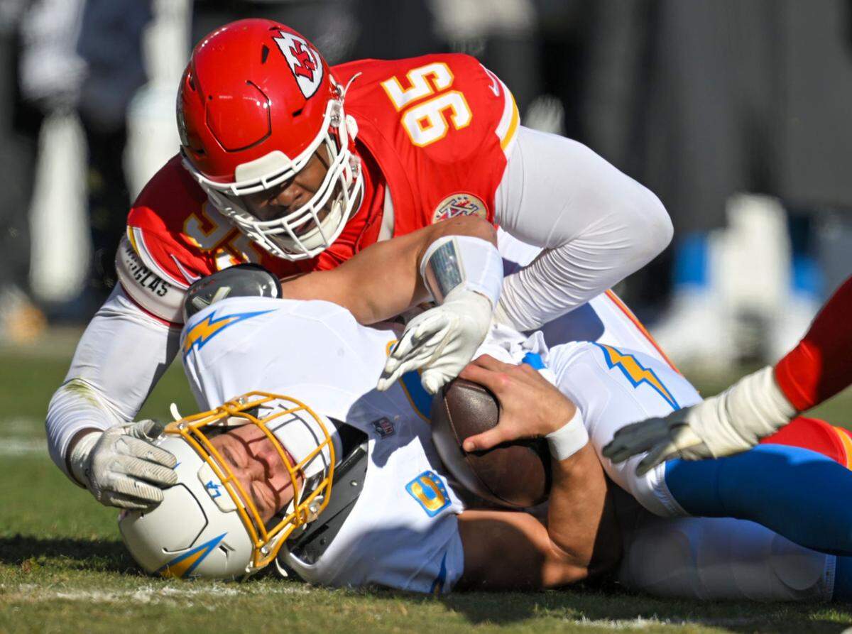 Kansas City Chiefs defensive end Chris Jones (95) tackles Los Angeles Chargers quarterback Justin Herbert (10) at GEHA Field at Arrowhead Stadium on Sunday, Dec. 14, 2025.