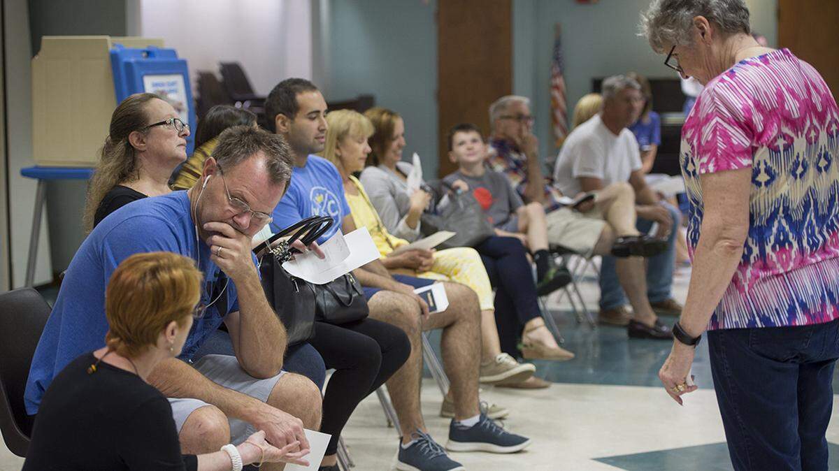 Voters in Johnson County waited Tuesday to cast a ballots on new voting machines at Colonial Church in Prairie Village. Election workers reported no problems and a steady stream of voters at the polling place. 