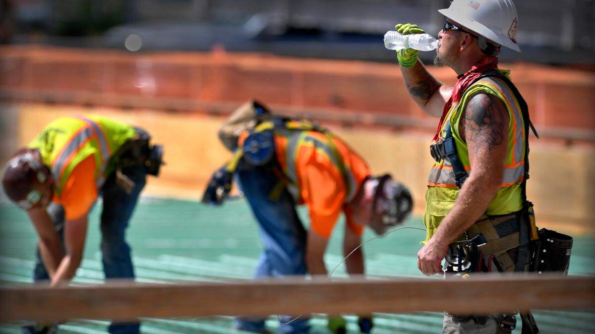 With the heat index in Kansas City topping the century mark Monday, Daniel Dennis, an iron worker with Local 10, paused for a cold drink water while he and a crew from Three Feathers Construction tied rebar together at Truman Road and Baltimore Ave., downtown. “You gotta do what you gotta do,” Dennis said about working in the extreme heat. Forecasters are calling for high’s in the upper 90’s for the remainder of the week.