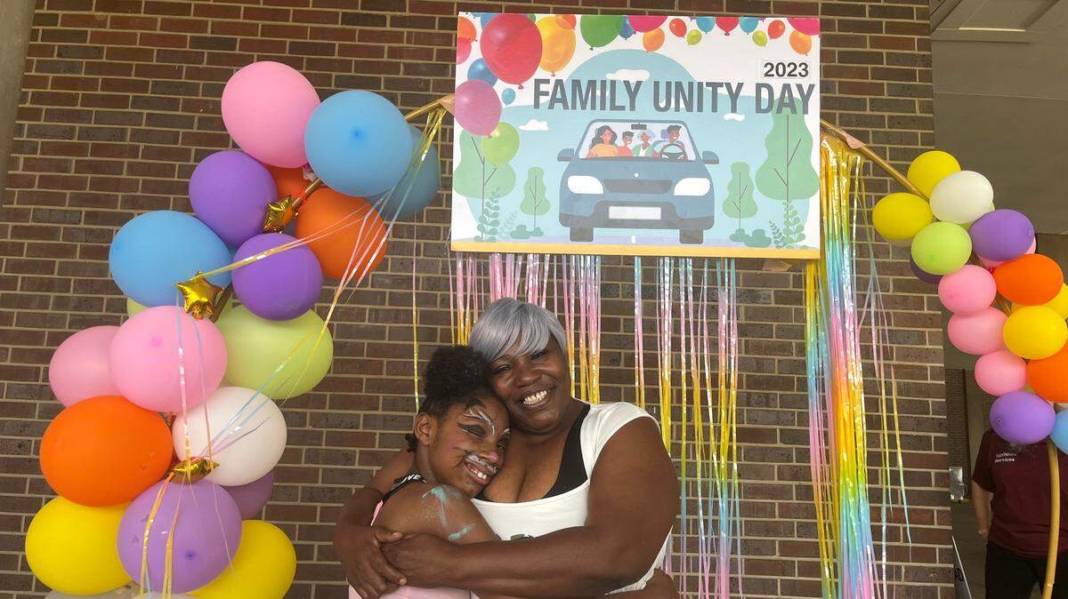 Pauline Green, right, and her daughter Denaria celebrated Family Unity Day outside the Jackson County Family Court along with a handful of other families who regained custody of their children.