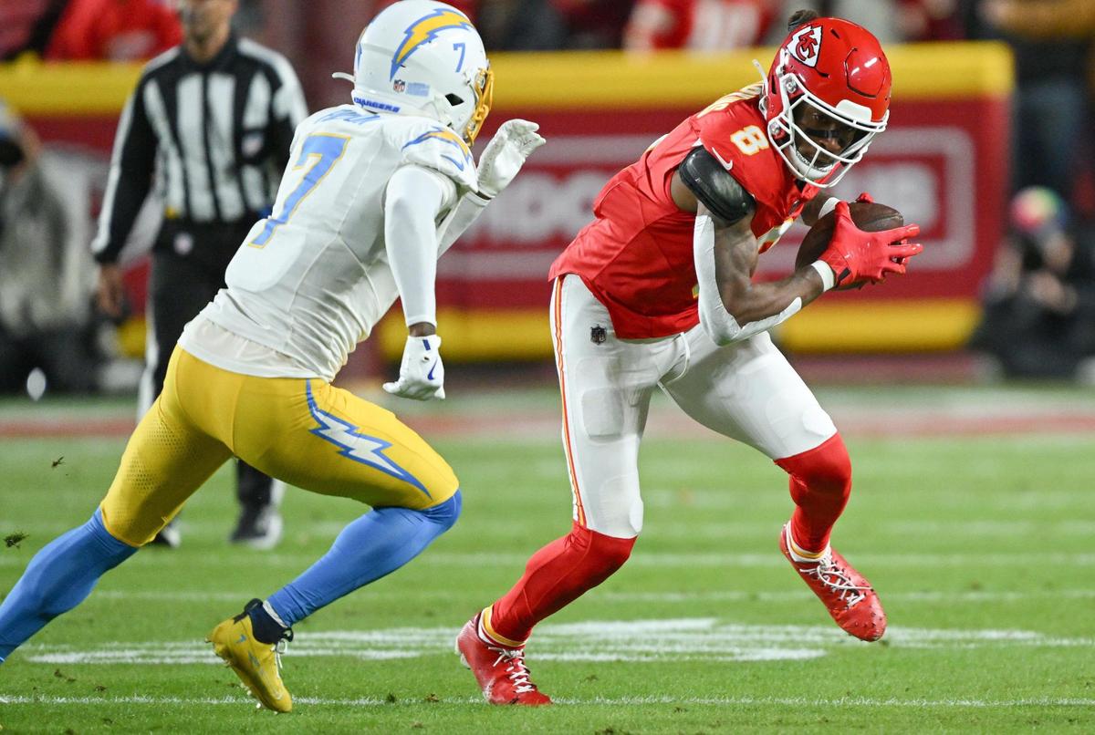 Kansas City Chiefs wide receiver DeAndre Hopkins (8) attempts to evade the defense of Los Angeles Chargers cornerback Kristian Fulton (7) in the first quarter on Sunday, Dec. 8, 2024, at GEHA Field at Arrowhead Stadium.