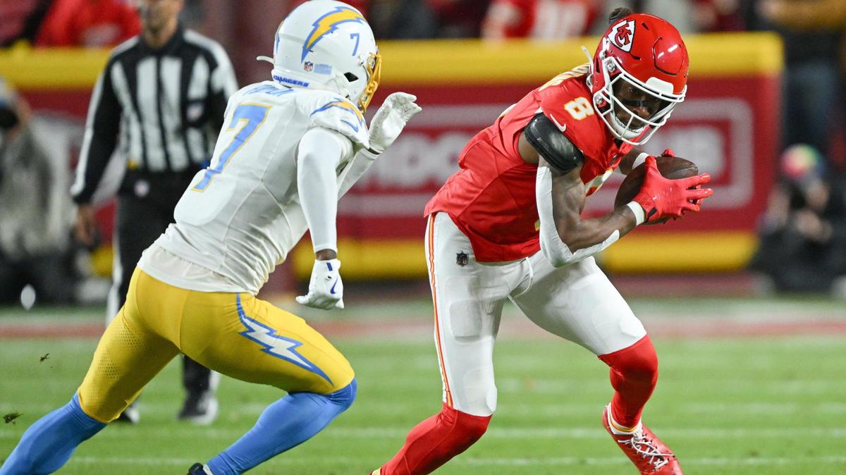 Kansas City Chiefs wide receiver DeAndre Hopkins (8) attempts to evade the defense of Los Angeles Chargers cornerback Kristian Fulton (7) in the first quarter on Sunday, Dec. 8, 2024, at GEHA Field at Arrowhead Stadium.