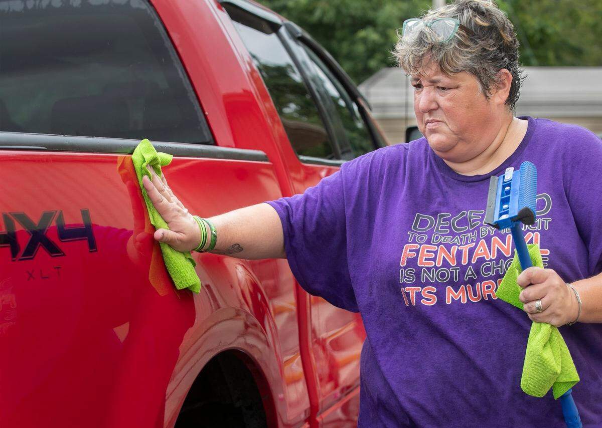 Jamie Fisher washed a car Saturday, August 26, 2023 during a car wash fund raiser to pay for billboards warning about Fentanyl. Fisher is one of the organizers of the fund raiser, her daughter Samantha died from Fentanyl. 92 names of people will who died from Fentanyl use will be on the billboard as well as special panels for her daughter Samantha and Gracie Humbird who died in June of this year. The two-day fund raiser, was held at moose lodge 2414, 2537 Blue Ridge Blvd. Kansas City.