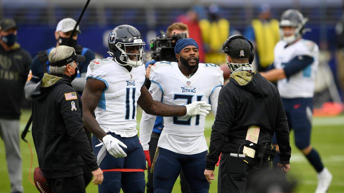 Baltimore Ravens head coach John Harbaugh, right, argues with Tennessee Titans cornerback Malcolm Butler, center, and wide receiver A.J. Brown (11) prior to an NFL football game, Sunday, Nov. 22, 2020, in Baltimore. (AP Photo/Nick Wass)