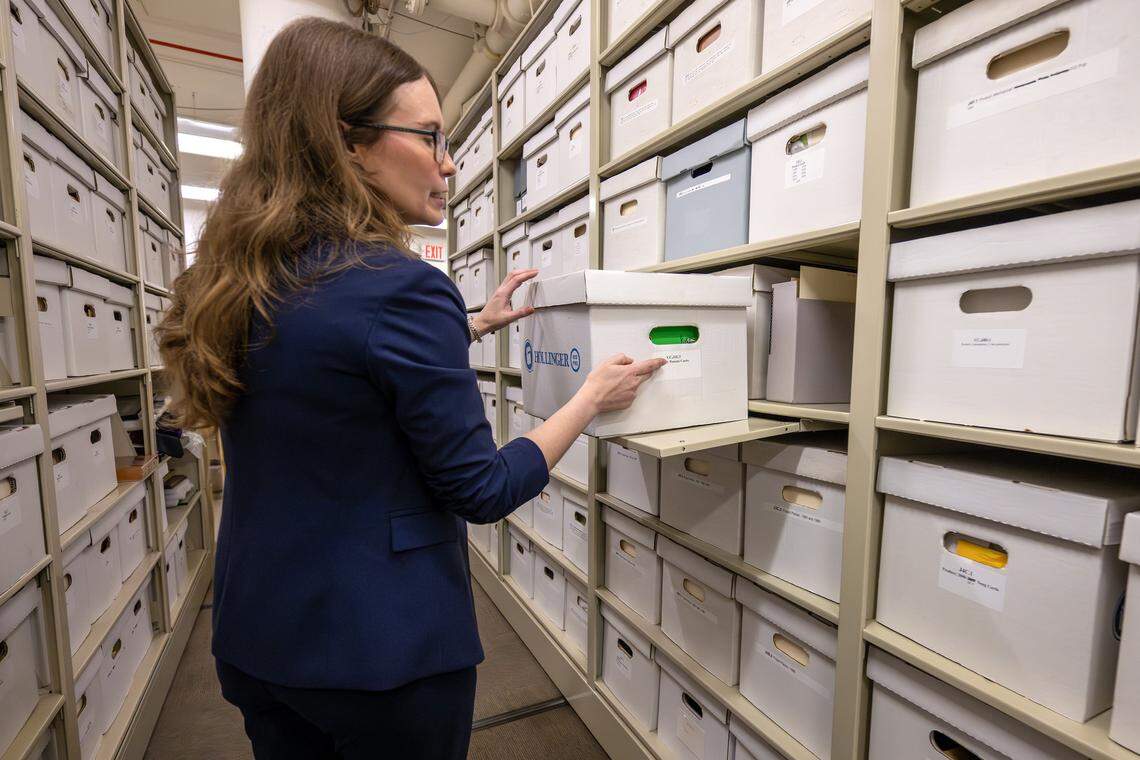 Archivist Samantha Bradbeer-Stephens points to a storage box labeled “Product: Peanuts Cards” while giving a tour of the Hallmark archives at the Hallmark headquarters on Aug. 5 in Kansas City. The archives are organized variously on holiday, themes or artists.