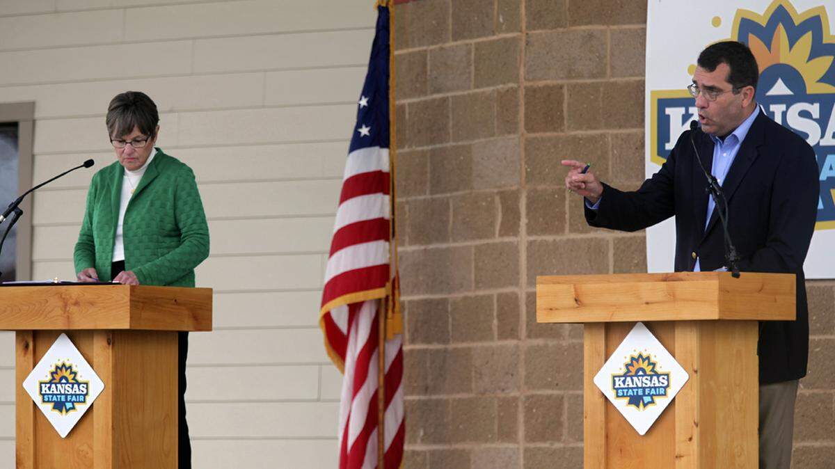 AG Derek Schmidt wants to talk about COVID-19 lockdowns and Gov. Laura Kelly keeps bringing up Sam Brownback.
