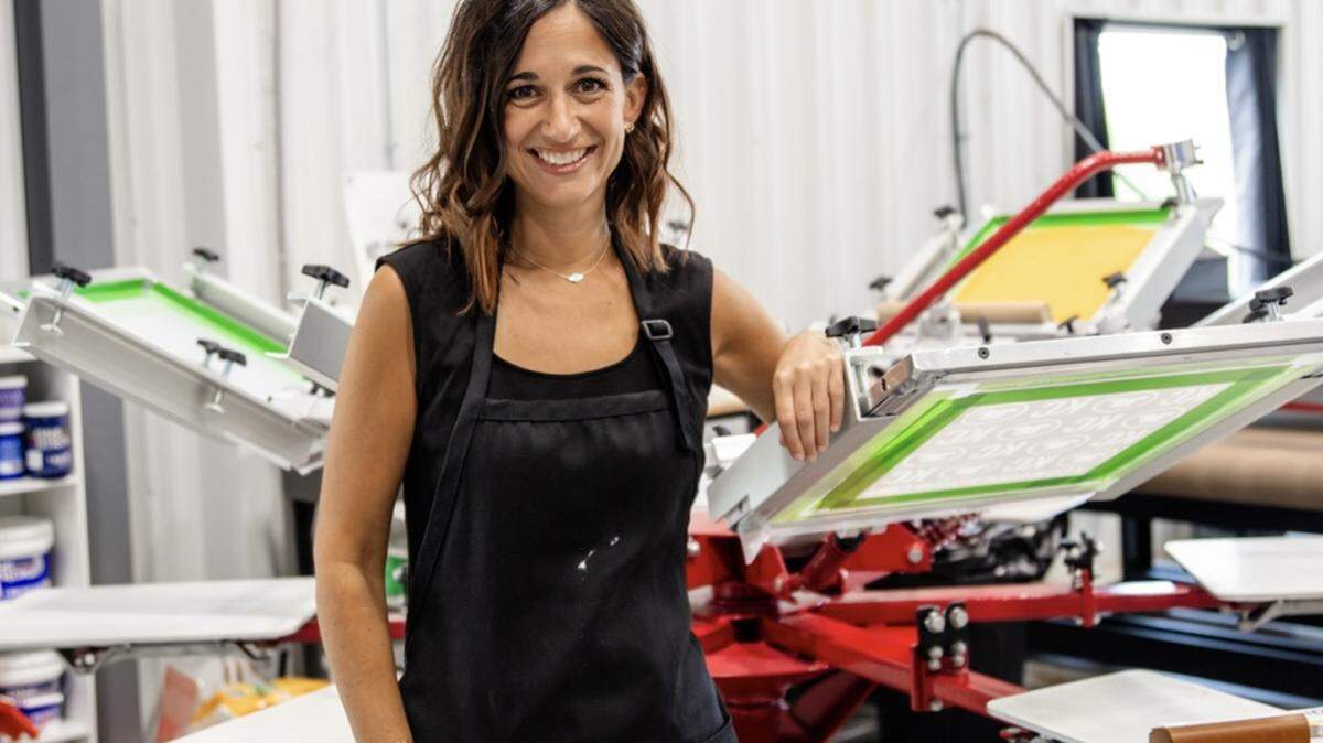 Gina Seibel works at the screen printing press at her store, KC Swagger in Lee’s Summit.