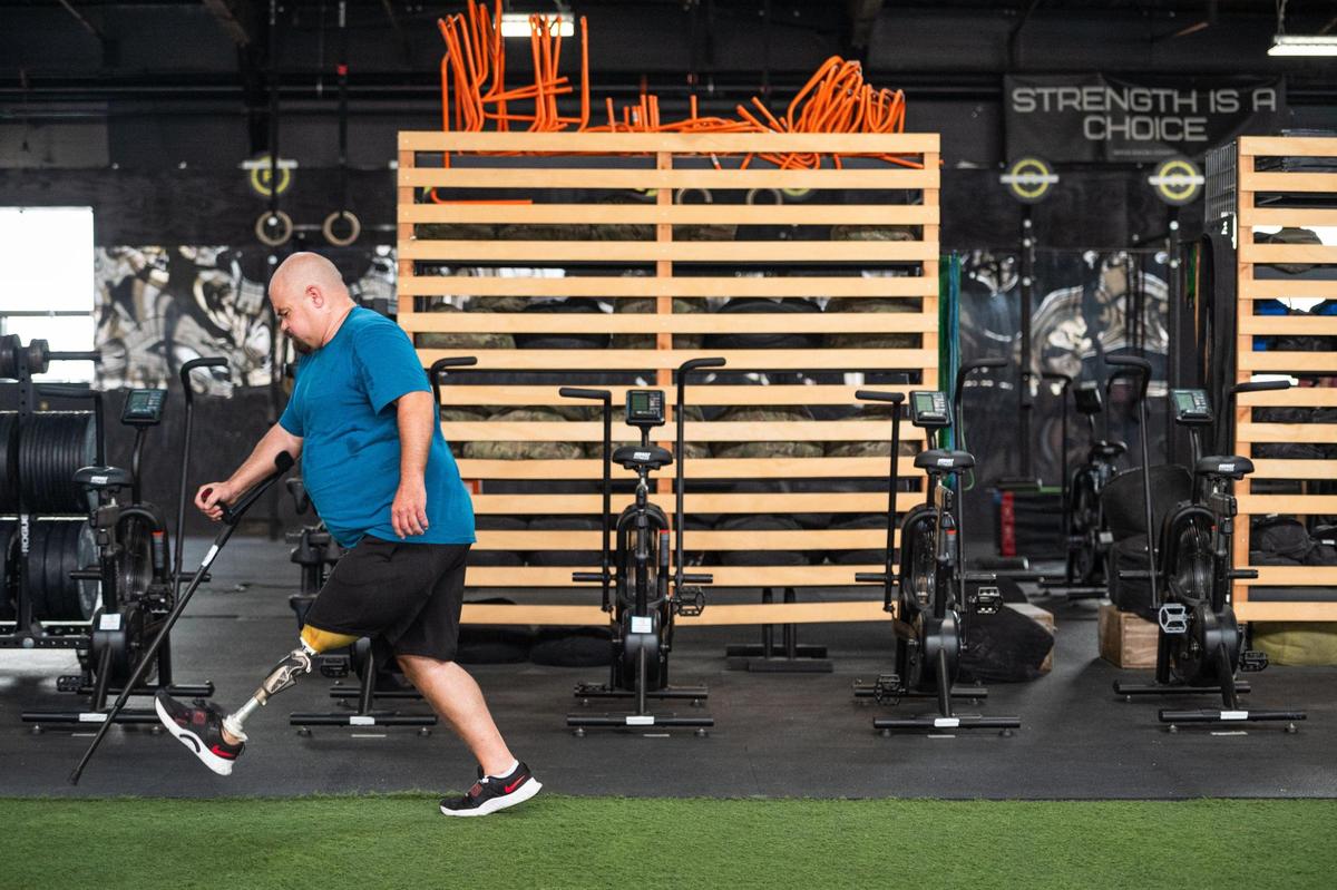 Daniel Bufford learns to walk with his prosthetic on Bufford’s workout routine consists of making laps around the Brave Enough CrossFit gym and participating in other strength training exercises.