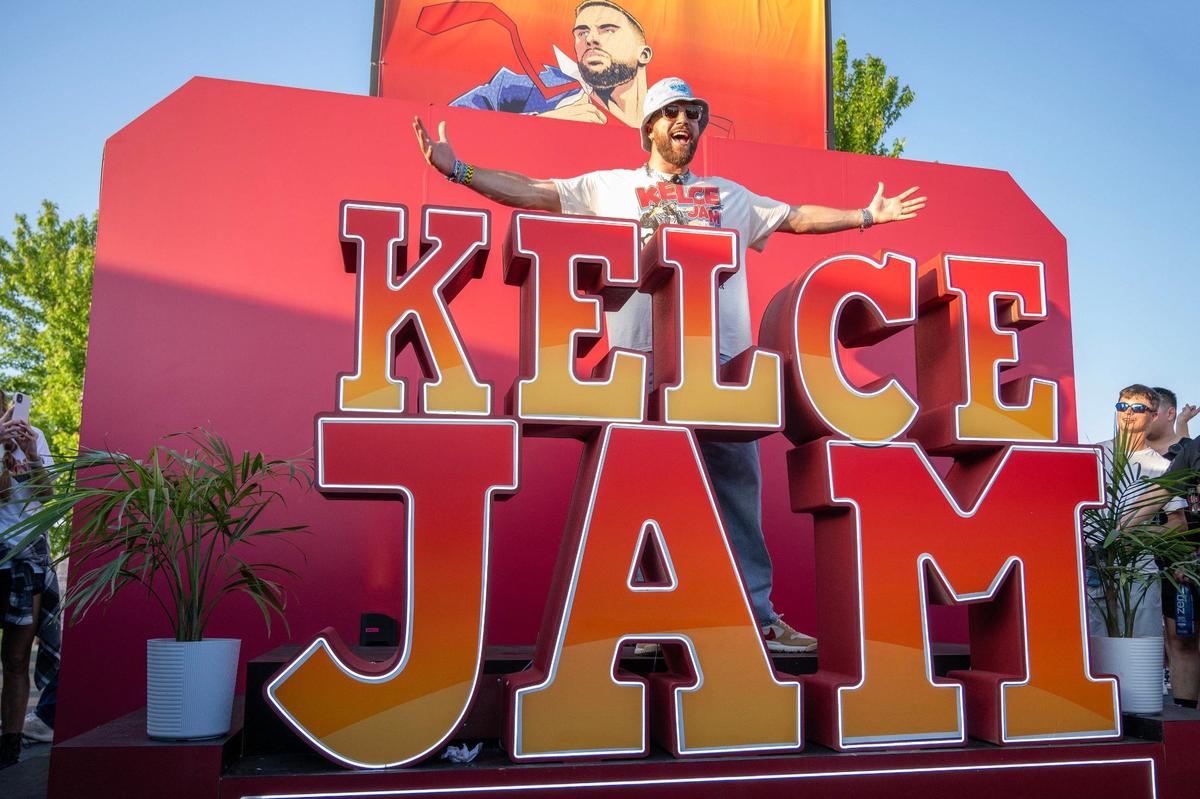 Kansas City Chiefs tight end Travis Kelce poses for photos next to the Kelce Jam logo during Kelce Jam at the Azura Amphitheater on Saturday, May 18, 2024, in Bonner Springs, Kansas.