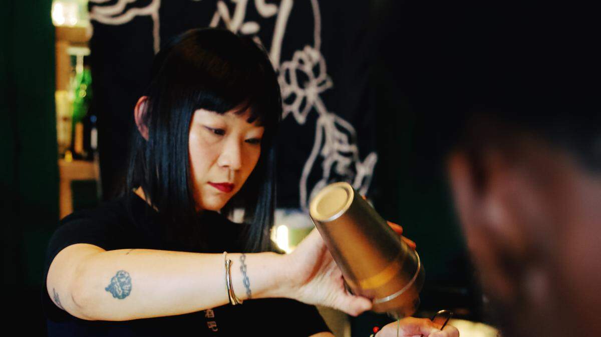 Moon Bar co-owner Saranya Hubbard pours drinks during service at the Columbus Park business, which operates as Tian Tea House during the day and transitions into Moon Bar in the evening.
