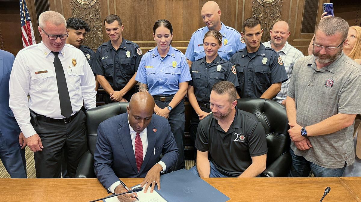 Kansas City Mayor Quinton Lucas celebrates the approval of a new five-year labor contract with members of Local 42 of the International Association of Fire Fighters in August.