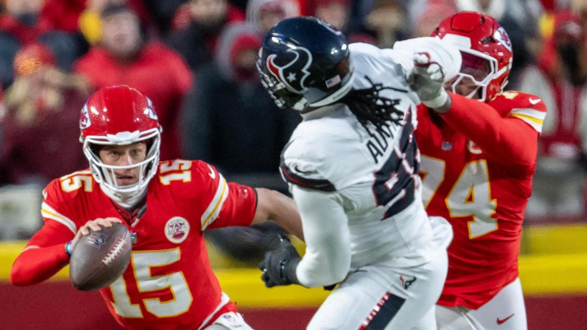Kansas City Chiefs quarterback Patrick Mahomes (15) scrambles with the ball as Chiefs offensive tackle Jawaan Taylor (74) tackles Houston Texans defensive end Denico Autry (96) in the second half of the AFC Divisional Round playoff game on Saturday, Jan. 18, 2025, at GEHA Field at Arrowhead Stadium. The Chiefs defeated the Texans 23-14.