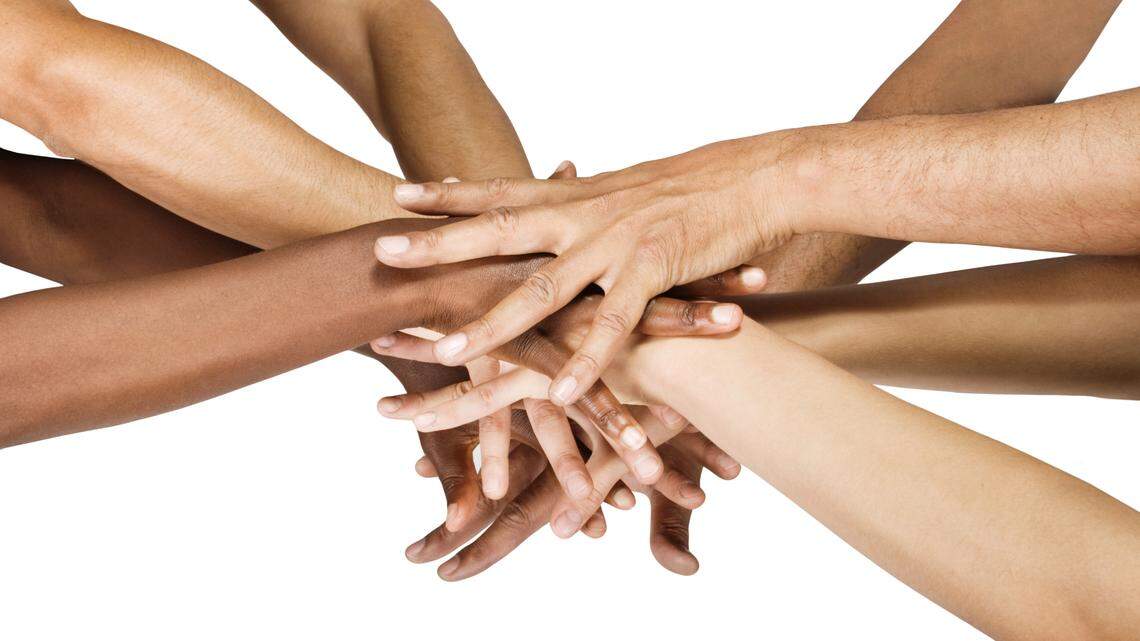 Pile of hands isolated on white, Caucasian, African American, Hispanic race.