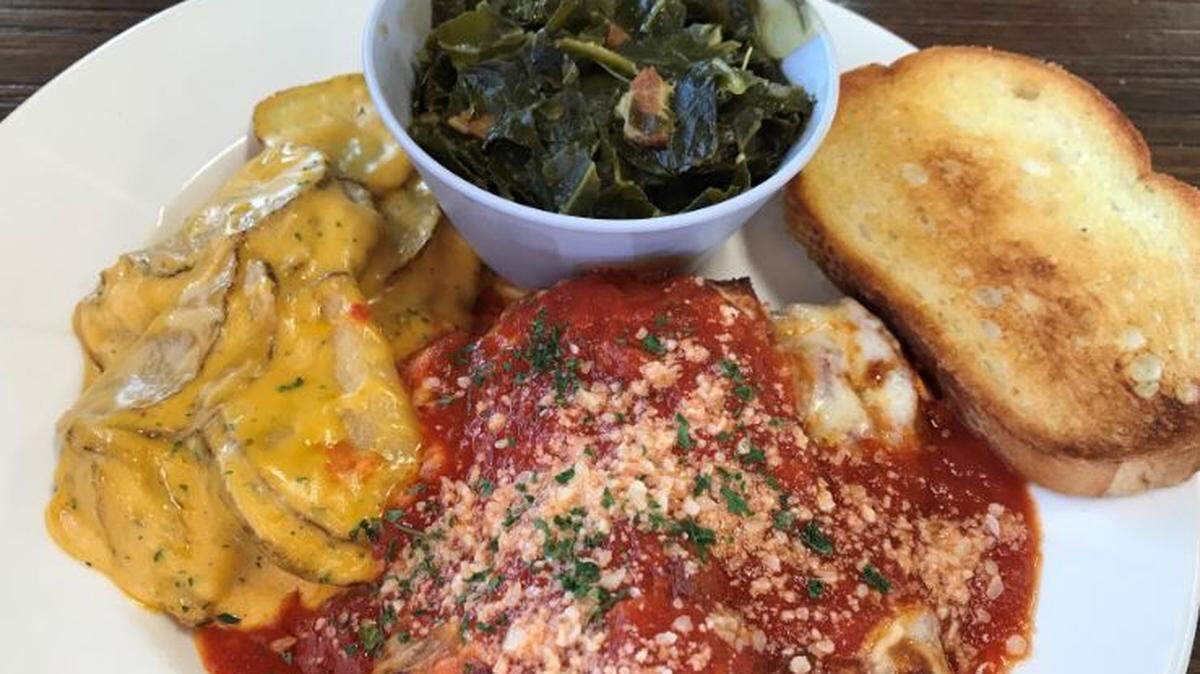 Big Belly’s chicken Parmesan with scalloped potatoes, collard greens and garlic bread.
