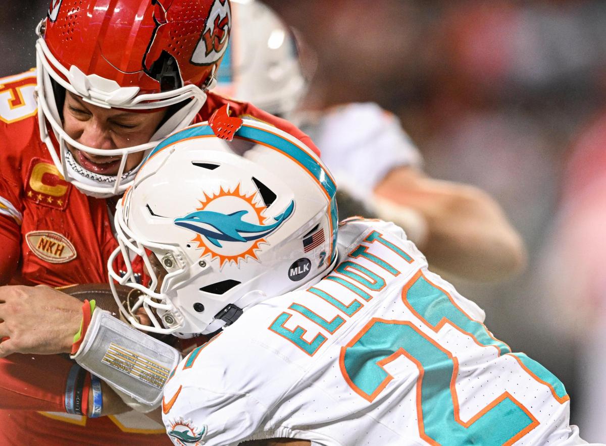 The helmet of Kansas City Chiefs quarterback Patrick Mahomes (15) breaks while being hit by Miami Dolphins safety DeShon Elliott (21) on a run in the third quarter Saturday, Jan. 13, 2024, at GEHA Field at Arrowhead Stadium.