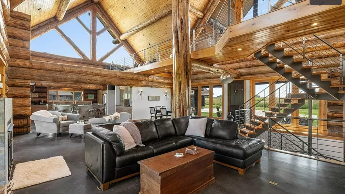The main floor of the log cabin-style home at 13708 South Missouri 7 Highway is seen in a listing on Zillow. 