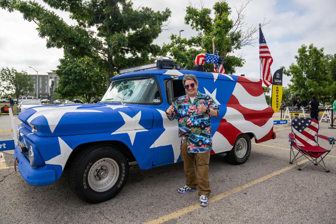 Paul Craig of Olathe, stands next to his panel van emblazoned with the American flag on all sides at the Hot Wheels Legends Tour on Saturday, July 12, 2005. Craig had his car covered in rubber so that kids can touch and climb on top of the car at events like these, where they can’t often touch the cars on display.