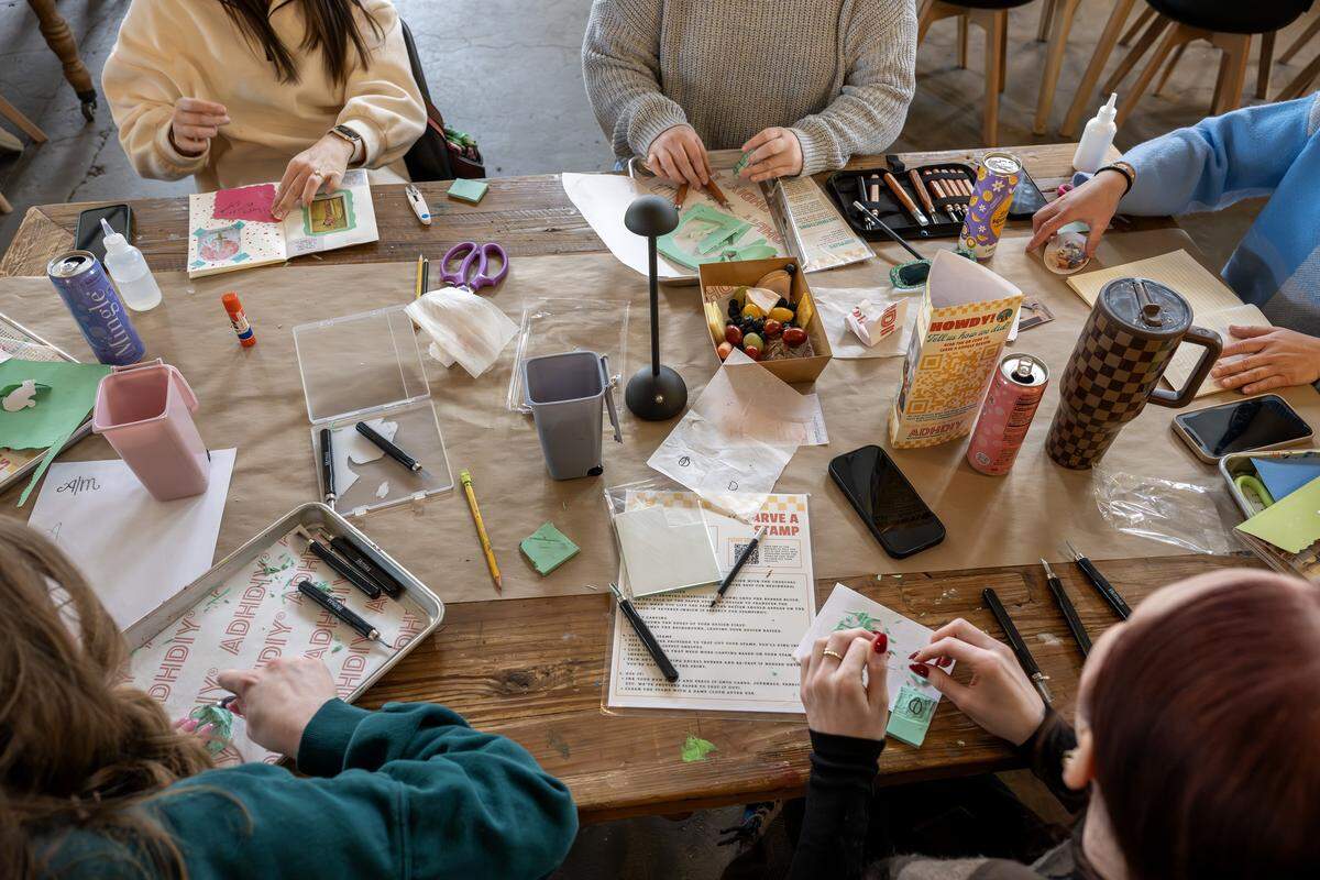 Guests sit at a table making various crafts at ADHDIY Craft Cafe on Saturday, Feb. 7, 2026, in Kansas City.