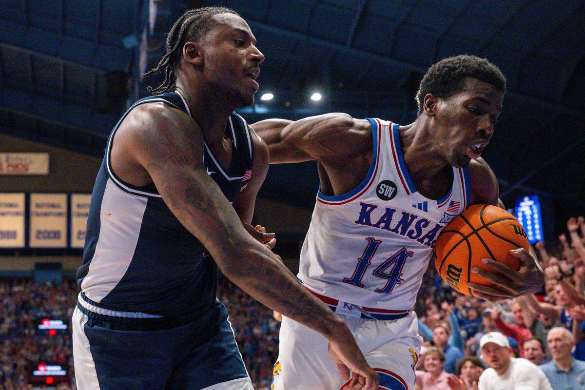 Kansas Jayhawks guard Melvin Council Jr. (14) wrestles the ball away from an Arizona Wildcats defender in the second half on Monday, February 9, 2026, at Allen Fieldhouse.