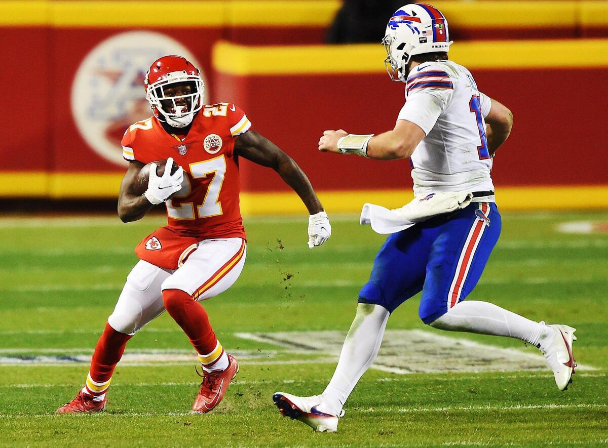 Kansas City Chiefs cornerback Rashad Fenton runs past Buffalo Bills quarterback Josh Allen after he intercepted a pass from Allen in the fourth quarter Sunday, January 24, 2021, during the AFC Championship Game at Arrowhead Stadium in Kansas City, Missouri.