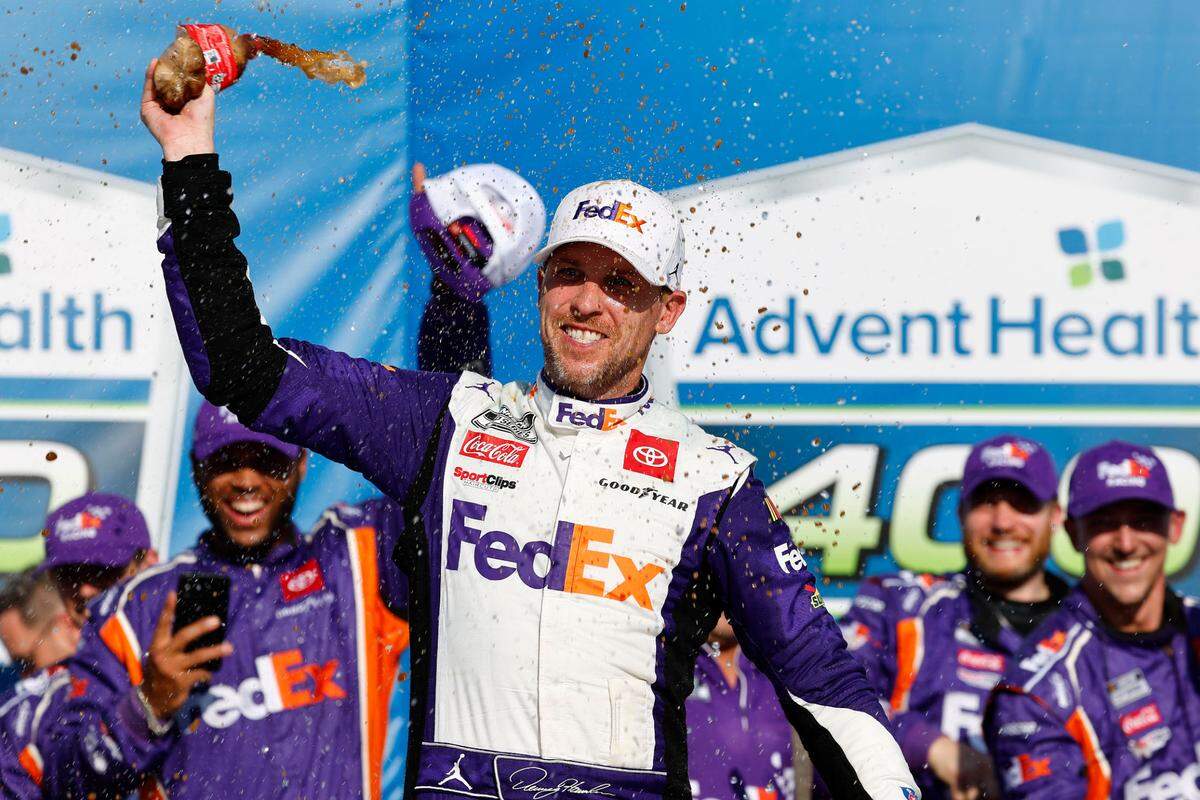 NASCAR Cup Series driver Denny Hamlin rejoices in victory lane after winning Sunday’s AdventHealth 400 race at Kansas Speedway in Kansas City, Kan.